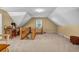 Bright bonus room featuring neutral walls and carpet, a window, and a wood railing overlooking the floor below at 441 Belgrave Ln, Tucker, GA 30084