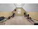 Bright bonus room featuring neutral walls and carpet, a window, and exercise equipment at 441 Belgrave Ln, Tucker, GA 30084