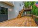 Spacious wooden deck featuring an American flag, staircase, and door with glass panes at 441 Belgrave Ln, Tucker, GA 30084