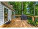 Wooden deck with a grill, plants, and sliding glass door, offering serene outdoor living at 441 Belgrave Ln, Tucker, GA 30084