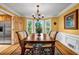 Formal dining room features natural light, hardwood floors, and elegant chandelier at 441 Belgrave Ln, Tucker, GA 30084