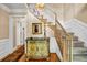 Classic home entryway with staircase, decorative console table, and hardwood floors at 441 Belgrave Ln, Tucker, GA 30084