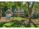 Charming two-story home with a landscaped front yard and a cozy seating area at 441 Belgrave Ln, Tucker, GA 30084
