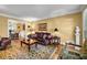 Cozy living room with hardwood floors, crown molding, and traditional decor at 441 Belgrave Ln, Tucker, GA 30084