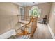 Elegant staircase with wooden banister leading to the lower level and featuring a large window at 441 Belgrave Ln, Tucker, GA 30084
