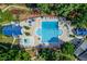 Aerial view shows the large community pool with ample lounging and mature trees at 218 Oakmoor Ct, Lawrenceville, GA 30043
