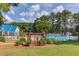 Community pool with blue umbrellas and lounging chairs at 218 Oakmoor Ct, Lawrenceville, GA 30043