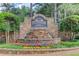 Stone entrance sign with water feature and beautiful flower bed at Edgewater community at 218 Oakmoor Ct, Lawrenceville, GA 30043