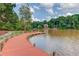 Picturesque lake view with a private wooden dock, perfect for relaxation and enjoying waterfront living at 218 Oakmoor Ct, Lawrenceville, GA 30043