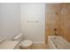 Bathroom with a bathtub featuring tiled wall, a toilet, and a vanity at 3101 Reeves Se St, Smyrna, GA 30080