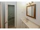 Bathroom vanity featuring a mirror, sink, and storage, with a view into a hallway at 3101 Reeves Se St, Smyrna, GA 30080