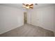 Bedroom featuring neutral carpet, ceiling fan, and two doors for closet and hallway access at 3101 Reeves Se St, Smyrna, GA 30080