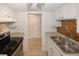 Galley kitchen with stainless steel appliances, and tan tile backsplash at 3101 Reeves Se St, Smyrna, GA 30080