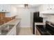 Galley kitchen with stainless steel appliances, and tan tile backsplash at 3101 Reeves Se St, Smyrna, GA 30080