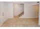 Tiled living room featuring a staircase, white walls, and modern neutral flooring at 3101 Reeves Se St, Smyrna, GA 30080