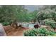View of community fenced pool with lounge chairs, tables and grill with landscaping around the edge at 3101 Reeves Se St, Smyrna, GA 30080