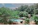 A common area fenced pool with chairs, tables and grill surrounded by trees and some landscaping at 3101 Reeves Se St, Smyrna, GA 30080