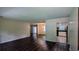 Open-concept living space with hardwood floors and views into the kitchen and dining area at 5177 Mccarter Sta, Stone Mountain, GA 30088