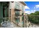 Condo balcony view with glass railing, outdoor seating, and a beautiful view of the building's exterior at 905 Juniper Ne St # 701, Atlanta, GA 30309