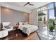 Modern bedroom with hardwood floors, large windows, and a work desk area for a stylish and functional space at 905 Juniper Ne St # 701, Atlanta, GA 30309