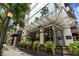 Low angle of building exterior with outdoor seating and a decorative, transparent canopy over the sidewalk at 905 Juniper Ne St # 701, Atlanta, GA 30309