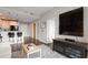 Open-concept living room with hardwood floors, stylish seating, and a view of the kitchen at 905 Juniper Ne St # 701, Atlanta, GA 30309