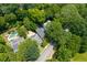 Aerial view of a home with a pool, solar panels, and surrounded by lush greenery at 1300 North Ne Ave, Atlanta, GA 30307