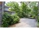 Driveway near building with gravel surface and carport, surrounded by green foliage at 1300 North Ne Ave, Atlanta, GA 30307