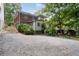 Rear exterior of home with brick accents, and a graveled parking area at 1300 North Ne Ave, Atlanta, GA 30307