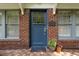 Inviting blue front door with brick surround, sidelight windows, and house number at 1300 North Ne Ave, Atlanta, GA 30307