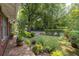 Landscaped front yard with lush greenery, brick walkway, and mature trees at 1300 North Ne Ave, Atlanta, GA 30307