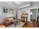 Living room with cozy leather furniture and wood floors at 1300 North Ne Ave, Atlanta, GA 30307