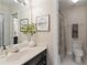 Cozy bathroom with shower featuring a large vanity and a decorative mirror at 1755 Noblin Summit Dr, Duluth, GA 30097