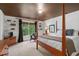 Bedroom featuring a four post bed, wood trim, and a window view at 1755 Noblin Summit Dr, Duluth, GA 30097