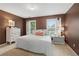 Cozy bedroom with lots of natural light features a window view and a neutral color palette at 1755 Noblin Summit Dr, Duluth, GA 30097