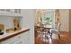 Close up of a butler's pantry with wood countertop with dining area beyond at 1755 Noblin Summit Dr, Duluth, GA 30097