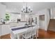 Open dining room with stylish chandelier, staircase, and modern decor at 1755 Noblin Summit Dr, Duluth, GA 30097