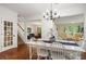 Open dining room with hardwood floors, views, and access to other rooms at 1755 Noblin Summit Dr, Duluth, GA 30097
