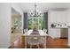 Bright dining room with white table, view of trees, and kitchen access at 1755 Noblin Summit Dr, Duluth, GA 30097
