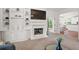 Open-concept living area with a cozy fireplace, built-in cabinets, and a seamless flow to the adjacent kitchen at 1755 Noblin Summit Dr, Duluth, GA 30097