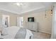 Bright main bedroom features a ceiling fan, tray ceiling and a TV console with lots of storage at 1755 Noblin Summit Dr, Duluth, GA 30097
