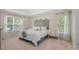 Serene main bedroom with tray ceiling, natural light, and neutral decor at 1755 Noblin Summit Dr, Duluth, GA 30097