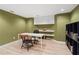 Office with hardwood floors, recessed lighting, olive green paint, built in white cabinets and a desk at 1755 Noblin Summit Dr, Duluth, GA 30097