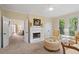 Cozy sitting room with fireplace, seating, and natural views at 1755 Noblin Summit Dr, Duluth, GA 30097