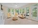 Bright sunroom with decorative seating, natural light, and deck access at 1755 Noblin Summit Dr, Duluth, GA 30097