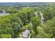 An aerial shot showcases the home's setting among lush greenery and a peaceful neighborhood at 2070 Drew Valley Ne Rd, Brookhaven, GA 30319