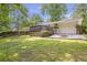 Spacious backyard with a wooden deck, fire pit, and lawn is perfect for outdoor entertaining at 2070 Drew Valley Ne Rd, Brookhaven, GA 30319