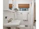 Stylish bathroom with pedestal sink, window, and a combination shower and tub at 2070 Drew Valley Ne Rd, Brookhaven, GA 30319