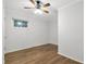 Cozy bedroom featuring a ceiling fan, hardwood floors and a window with natural light at 2070 Drew Valley Ne Rd, Brookhaven, GA 30319