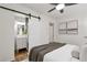 Stylish bedroom with a barn door leading to a modern en-suite bathroom, combining convenience and elegant design at 2070 Drew Valley Ne Rd, Brookhaven, GA 30319